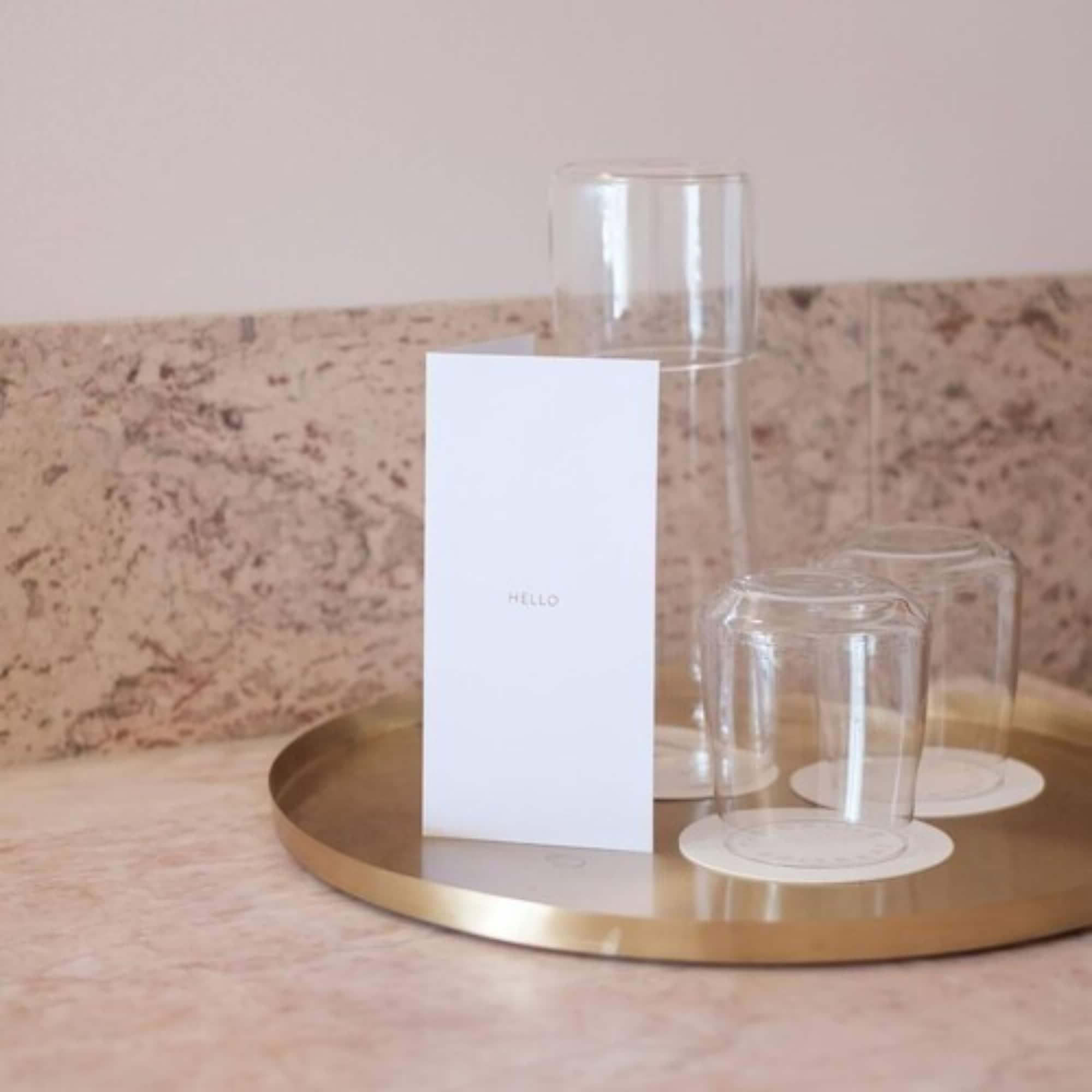 The Calile Hotel Brisbane Exteriör bild A tray of water and glasses at a hotel